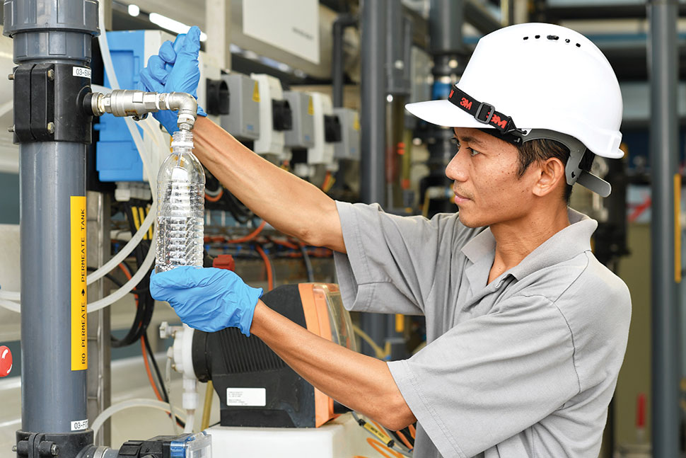 A Nestlé employee checking water from the DPRS system A Nestlé employee checking water from the DPRS system