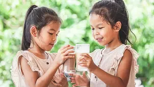 two girls clinking their glass