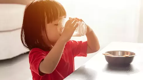 A girl drinking from a glass