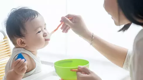 mother feeding her baby